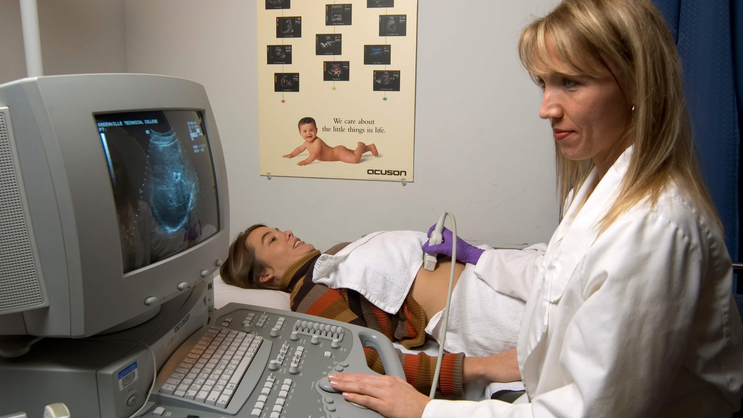An ultrasound technician performs an ultrasound on an expectant mother