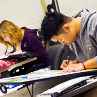 Students practicing engineering sketching in class